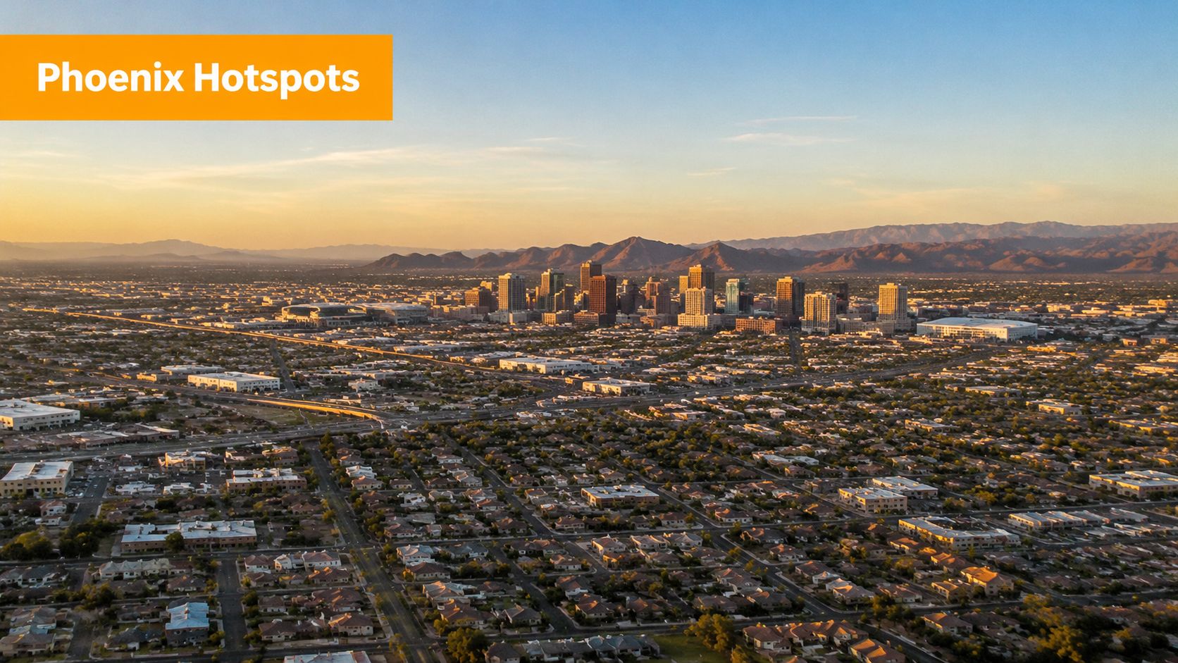 An aerial view of the Phoenix skyline at sunset with a residential neighborhood in the foreground.